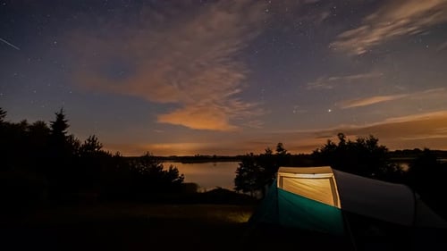 Night Time Lapse Over Calm Lake With Tent