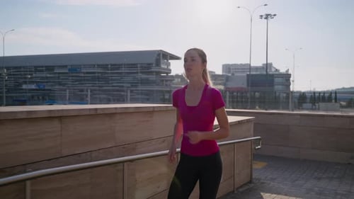 Female Jogger and Morning Sunshine in the City