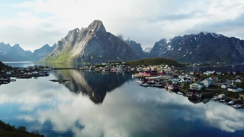 Bright red houses on the ocean. Footage of small fishing village on Lofoten islands in Norway.