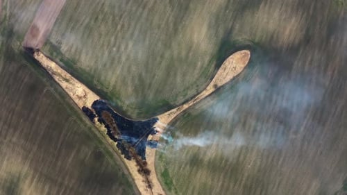 Aerial Top View of Wild Fire in Nature . Flying above fire on the field. Flyover Ecology