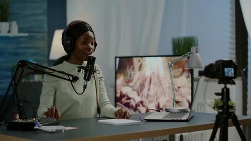 Woman Podcasting With Microphone and Camera at Table