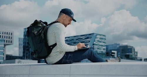 Hipster Man Work on Laptop in Business District