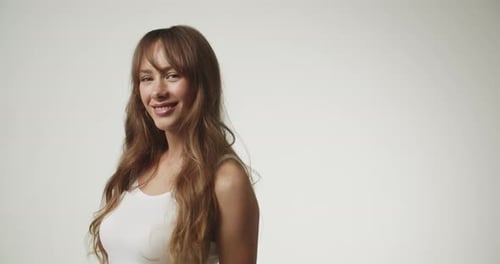 Beautiful Brunette Woman Smiling in Bright Studio