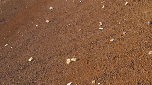 Close Up Plastic and Paper Garbage Moving By Wind Across Landfill Hawaii USA