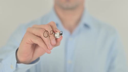 Man Writing Operating Instructions on Clear Surface