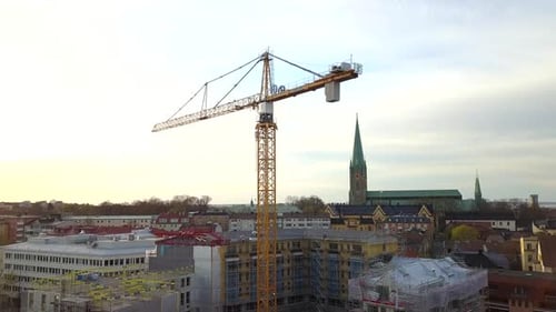 Aerial view of construction site of new residential building wint tower crane.