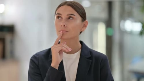 Young Adult Woman Thinking in Corporate Office