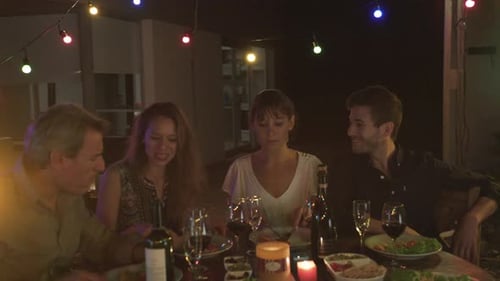 Four Friends Share a Meal and Toast