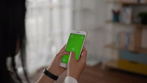 Closeup of hand woman using smartphone with green screen