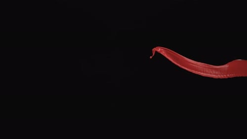 Scarlet Paint Streak Abstract Against Black Backdrop