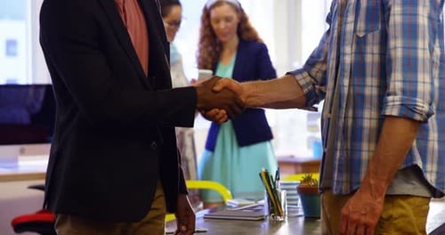 Business Professionals Handshake in Modern Office Setting