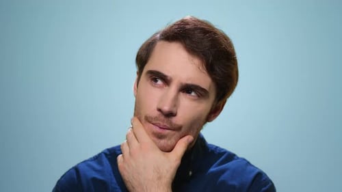 Thoughtful Man Posing in Studio. Close Up Serious Guy Thinking Problem Solution