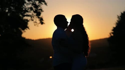 Romantic Couple Dancing Silhouetted at Sunset