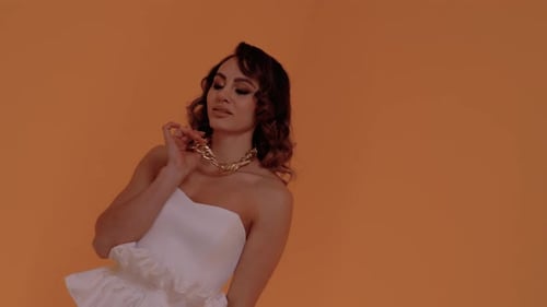 Woman Posing with Necklace in Studio