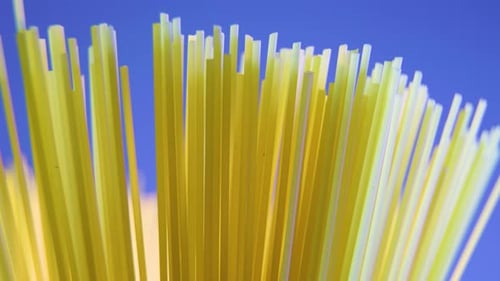 Close-up of Uncooked Spaghetti Pasta on Blue