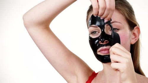 Woman Removing Black Peel-Off Facial Mask