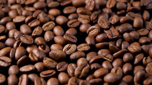 Close-up of falling roasted coffee beans