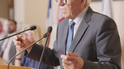 Man Gives Speech at Podium During Conference