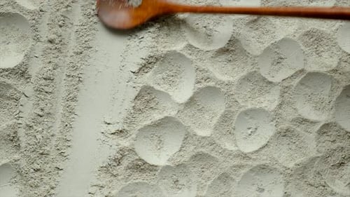 Wooden Spoon Removing Powder Revealing Circular Patterns