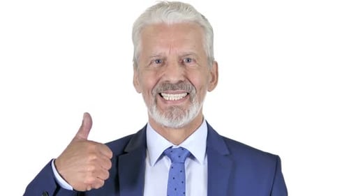 Smiling Mature Adult Gives Thumbs Up Gesture