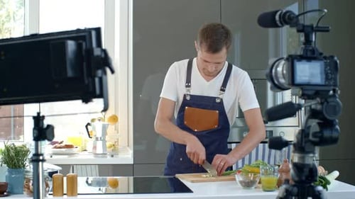 Young Man Preparing Food on Camera in Kitchen