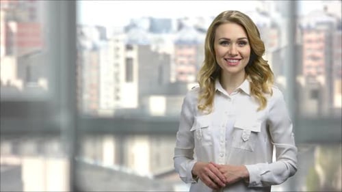 Smiling Woman Presenting in an Office Environment