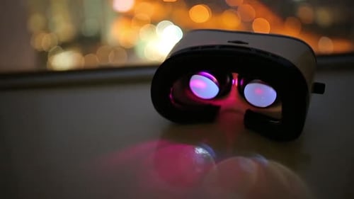 Virtual Reality Headset Overlooking a City at Night