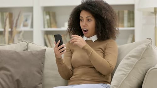 Woman Receives Shocking News on Smartphone, Reacts