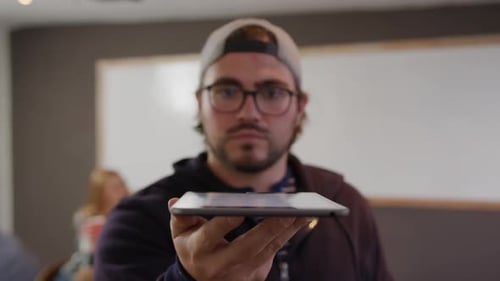 Caucasian man holding computer tablet in creative office