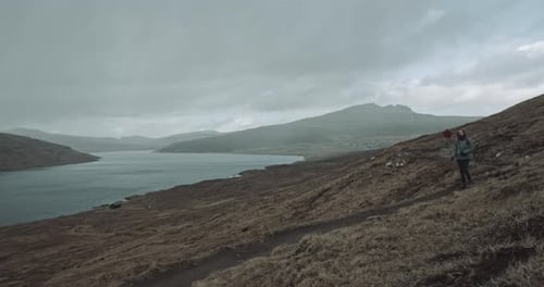 Two people walk together in the mountains