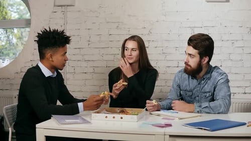 Business Team of Young People Enjoying Pizza Together in the Office Millennials Group Talking Having