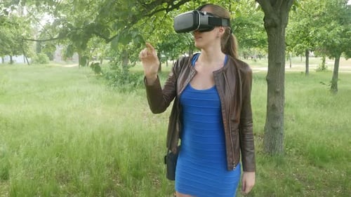 Woman Using VR Headset Outdoors in Park