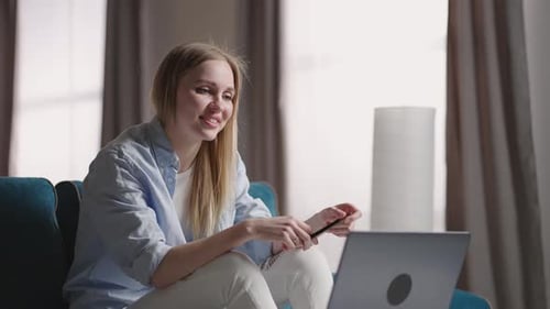 Woman on Couch Using Laptop for Video Chat