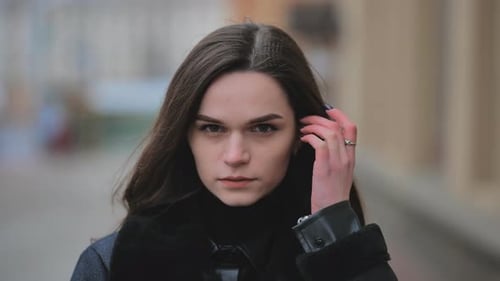 Portrait of a Young Girl on a City Street in Early Spring