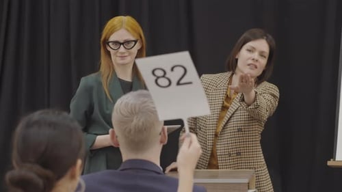 Exciting Auction With Bidders and Auctioneers Inside