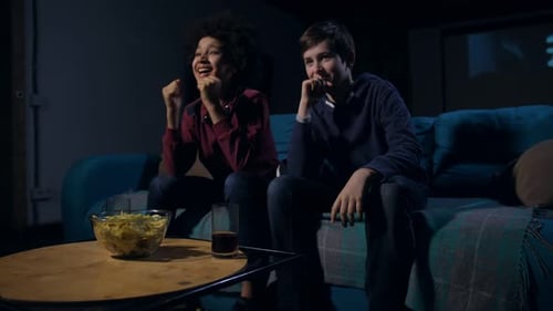 Teens Watching TV at Night Indoors