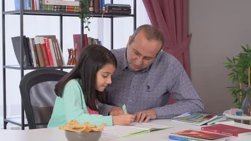 Man Helping Girl with Homework at Home