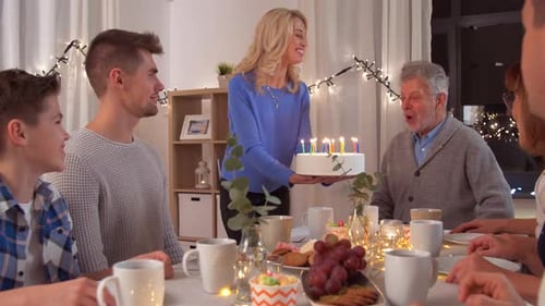Family Celebrates Birthday with Cake and Candles