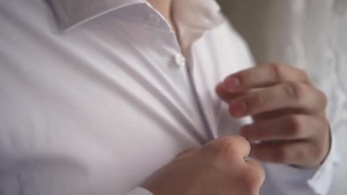 Man Buttoning Elegant White Shirt, Close Up