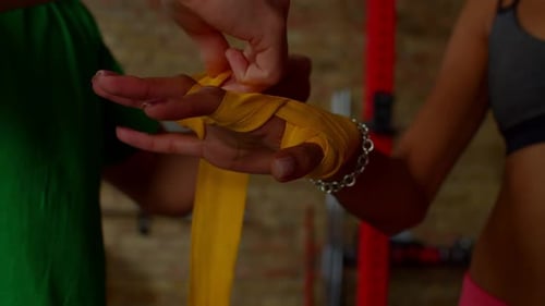 Hands Being Wrapped with Boxing Tape at Gym