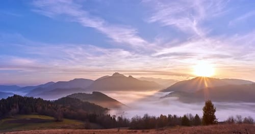 Fog moving in a valley in a mountain landscape at sunset.4K