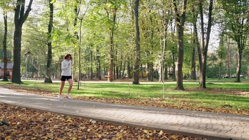 Woman Enjoying Morning Run at Park