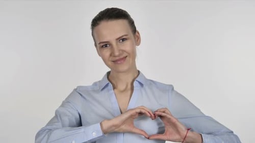 Smiling Woman Makes Heart with Hands on White