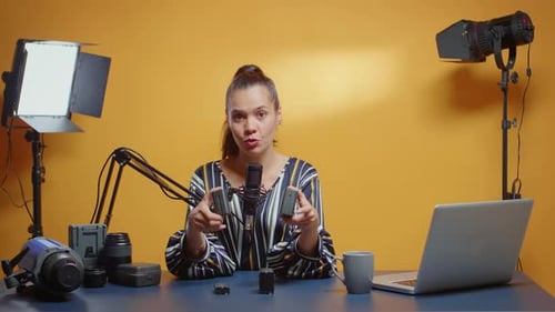 Woman Talking into Microphone in Studio Setting