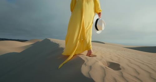 Closeup of Woman Legs Walking on Sand Barefoot in Desert