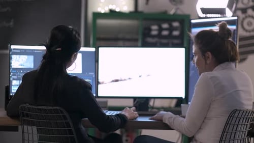 Adults Collaborating on Video Editing Project