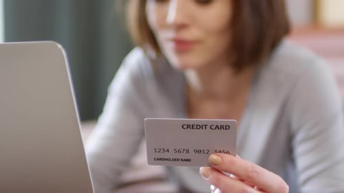 Woman Using Credit Card for Online Shopping