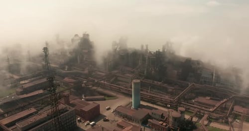 Epic Aerial of High Pipes with Smoke Emission