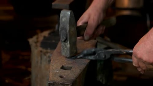 Shaping Metal on Anvil With Hammer and Tongs