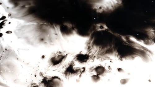 Abstract Ink Expanding Slowly on a White Surface